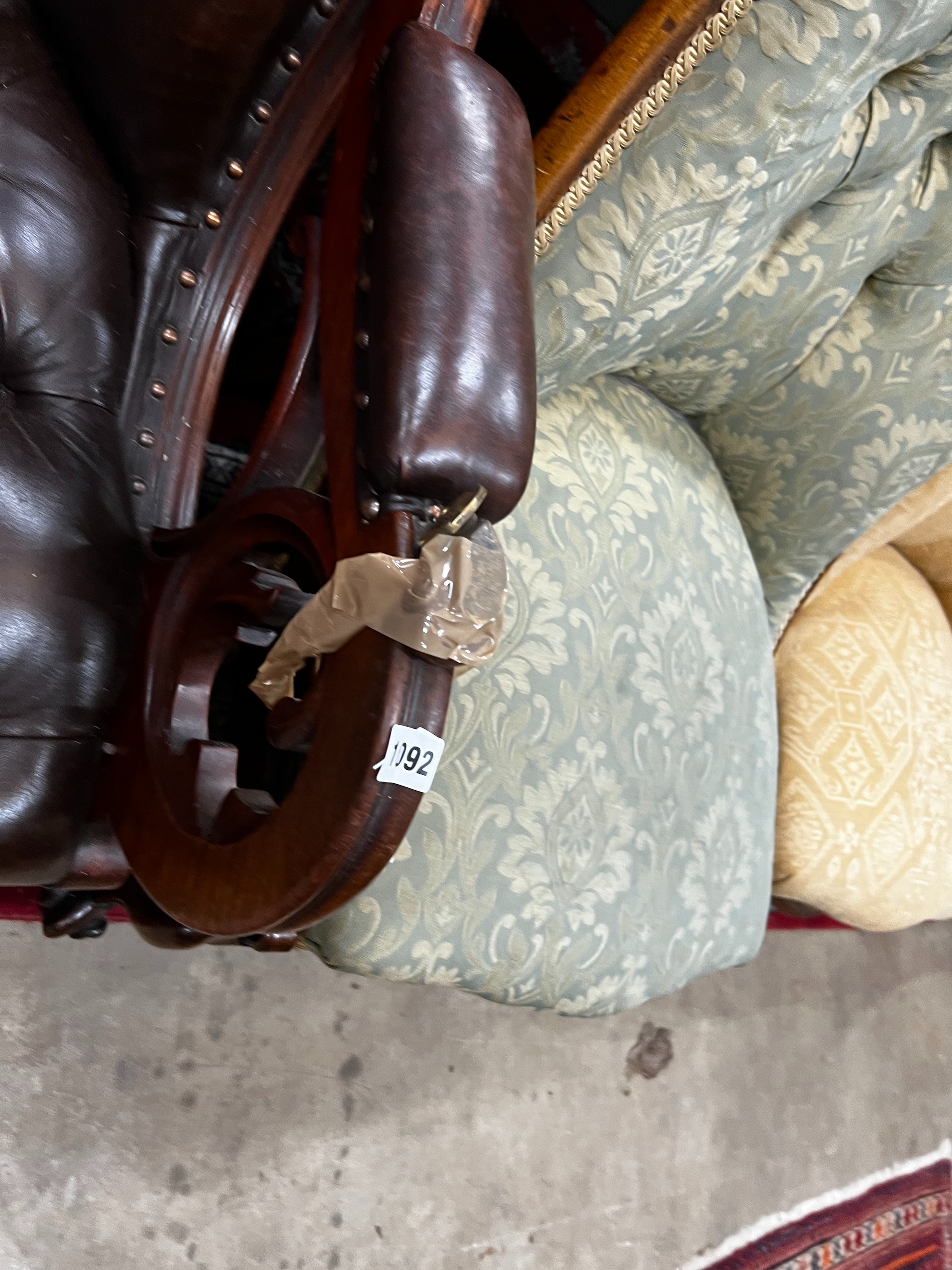 A Victorian mahogany armchair upholstered in deep buttoned brown leather, width 68cm, depth 80cm, height 96cm